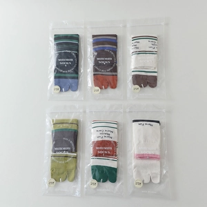 Detail of six pairs of striped two-toe tabi socks in individual 5A antibacterial packaging