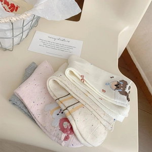 Close-up of cute cartoon bear and rabbit patterns on speckled knit cotton socks