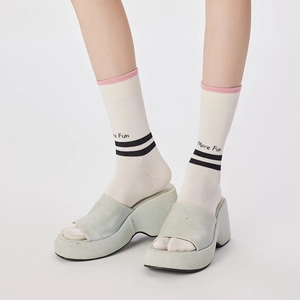 Striped two-toe tabi socks with More Fun print paired with platform denim sandals