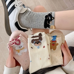 Detail of cute bear cartoon crew socks in cotton blend with colorful speckled dot texture