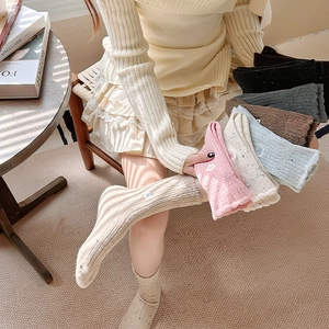 Detailed knit texture and bow embroidery on warm winter wool socks in various colors