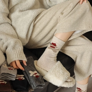 Detail showing cozy wool socks with cute puppy jacquard and knitted fabric texture