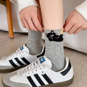 Cute grey mid-calf cotton socks with cat embroidery paired with stylish sneakers