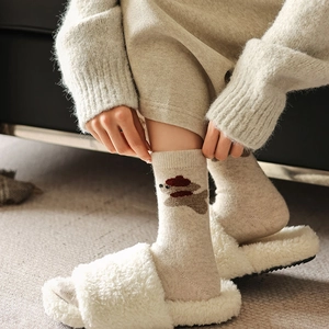 Detailed knit texture of wool socks featuring cute cartoon dog and cozy thermal fabric
