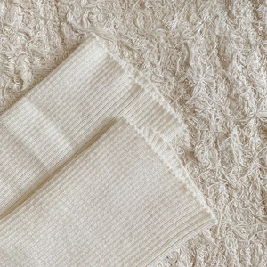 Detailed close-up of cream knit rib texture on Lolita leg warmers with soft fabric