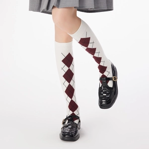 Detail of preppy argyle knee-high socks in ivory with wine red diamonds and rib cuff