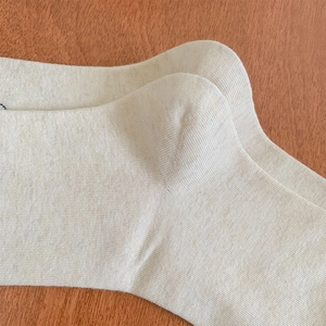 Détail du talon renforcé sur des chaussettes mi-hautes en coton tricoté beige