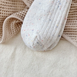 Detail of warm wool blend socks featuring colorful confetti yarn and ribbed knit texture
