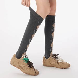Detailed view of elastic knit argyle knee-high socks showing flexible texture and vintage pattern