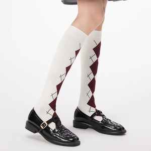 Detailed knit texture of argyle pattern calf high socks with Mary Jane shoes