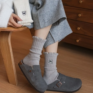 Close-up of cute dog embroidery on thick thermal knit socks for women in soft grey