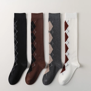 Detail of argyle pattern on cotton knee-high socks in black, brown, grey, and beige