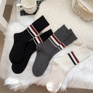 Close-up of three pairs of thick winter crew socks with classic striped ribbed texture