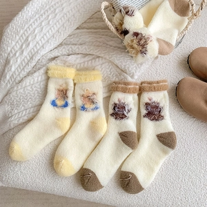 Detail of thick plush thermal socks featuring cute 3D cartoon animal decorations