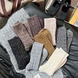 Gros plan de chaussettes épaisses en laine tricotée côtelée aux couleurs rétro d'hiver