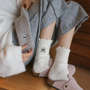 Thick knit crew socks for women featuring cute dog embroidery and ruffled edges