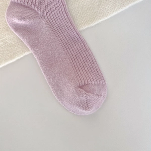 Detailed close-up of light purple ribbed knit winter socks with soft textured finish