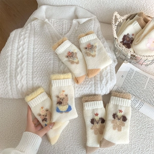 Close-up of thick winter socks with plush teddy bear patterns and fuzzy cuffs
