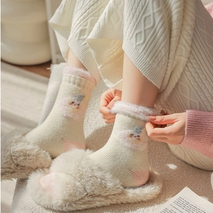 Detailed view of warm white thermal socks with pink plush cuffs and cute sheep patterns