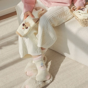 Detail of warm winter socks featuring cute cartoon bear and clown embroidery patterns