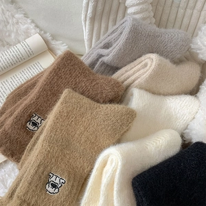 Detailed view of warm thickened coral fleece socks with cute cartoon puppy embroidery