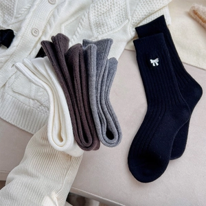 Gros plan de chaussettes en tricot côtelé avec broderie de nœud en couleurs d'automne