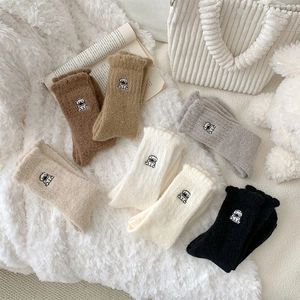 Detail of plush thermal socks with cute dog embroidery in six assorted earthy tones