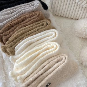 Close-up of thick thermal coral fleece socks in earthy tones with soft plush texture