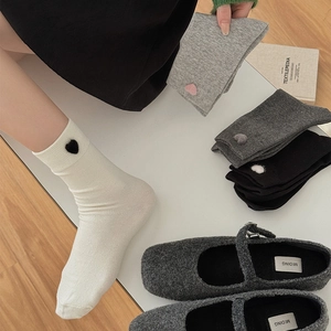 Detailed view of the ribbed cuff and velvet heart applique on these grey cotton socks