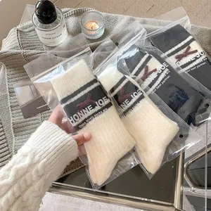 Detailed view of women's wool blend socks with bow decoration and striped patterns