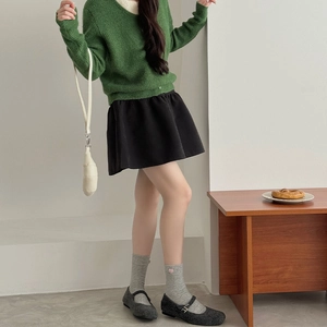 Women's forest green knit sweater and grey mid-tube socks with pink heart embroidery