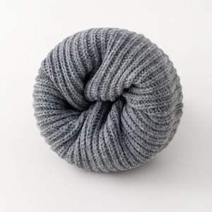 Detailed macro view of the grey ribbed knit texture and thick warm winter fabric