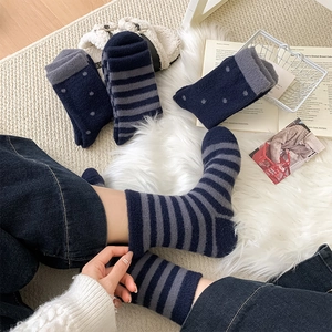 Thick plush fuzzy socks in dark blue and grey stripes with polka dot patterns for winter