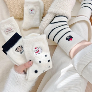 Detailed view of warm cream fleece socks featuring cute dog embroidery and striped cuffs