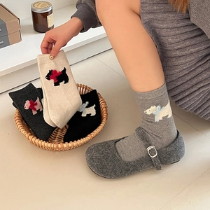 Close-up of thick wool socks with Scottish Terrier embroidery and 3D bow detail