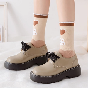 Classic beige platform lace-up shoes in college style with thick serrated brown soles