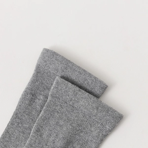 Close-up of gray over-the-knee socks showing ribbed cuffs and fine knit texture