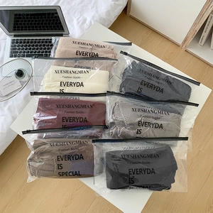 Detailed view of thick knit leg warmers in various colors packed in zipper bags