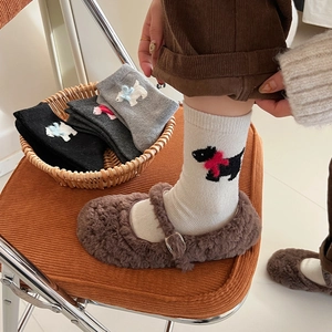 Detail of wool blend ribbed socks featuring cartoon dog embroidery and cute 3D bows