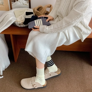 Cosy thermal striped crew socks paired with clogs in a warm lifestyle home setting