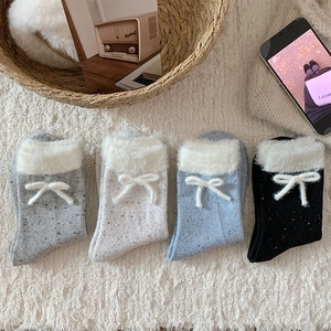 Detail of four-pack knit socks with faux fur trim and cute bows in assorted colors