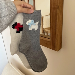Detailed close-up of wool socks featuring embroidered terrier dogs and 3D bowknot accents