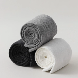 Three-pack of knit over-the-knee socks in black, grey, and white colors in a stack