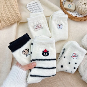 Detailed view of warm winter socks with cute puppy embroidery and striped patterns