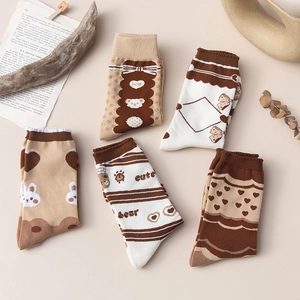 Close-up of five pairs of vintage style cotton socks with cute bear and heart patterns