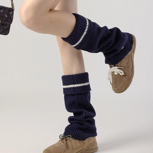 Thick navy knit leg warmers with white stripes and metal buckle for winter fashion styling