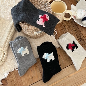Detailed knit texture of wool socks with 3D puppy motif and delicate bow decoration