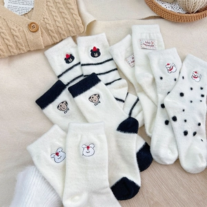 Detailed view of thick winter socks with cute cartoon embroidery and cozy plush texture