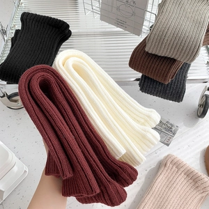 Detailed view of colorful ribbed knit leg warmers in various stylish autumn colors