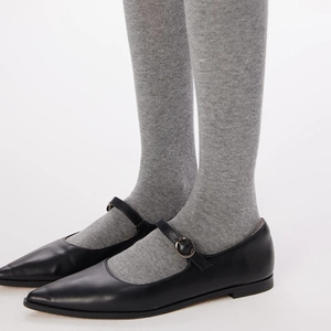 Detail of black pointed Mary Jane flats with metal buckle and matte leather texture